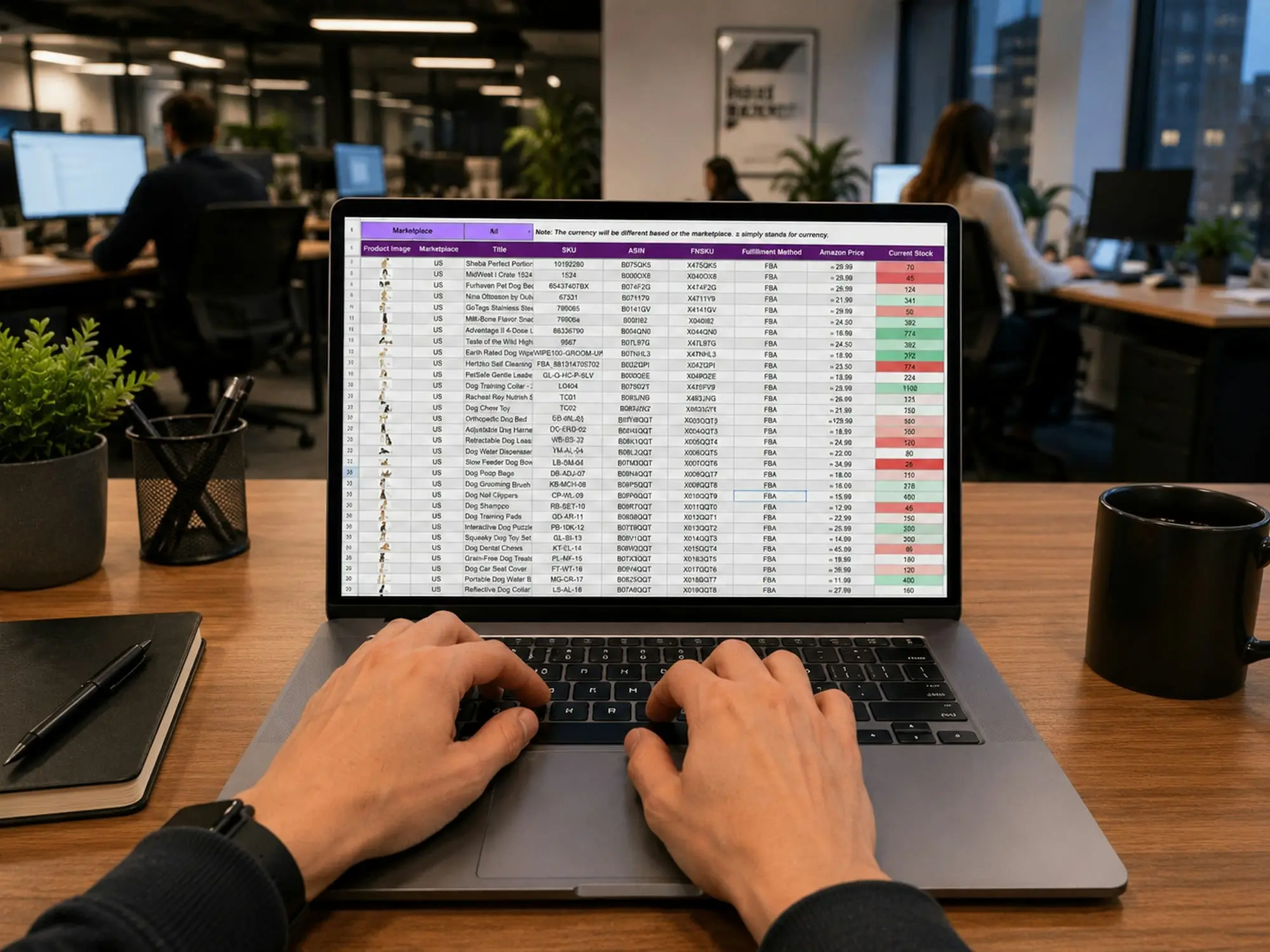 Hands typing on a laptop showing a spreadsheet of figures
