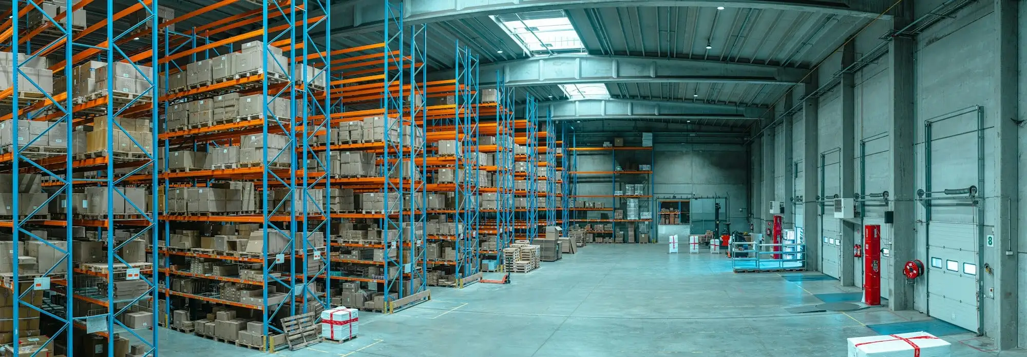Rows of blue warehouse racking stacked with boxed stock