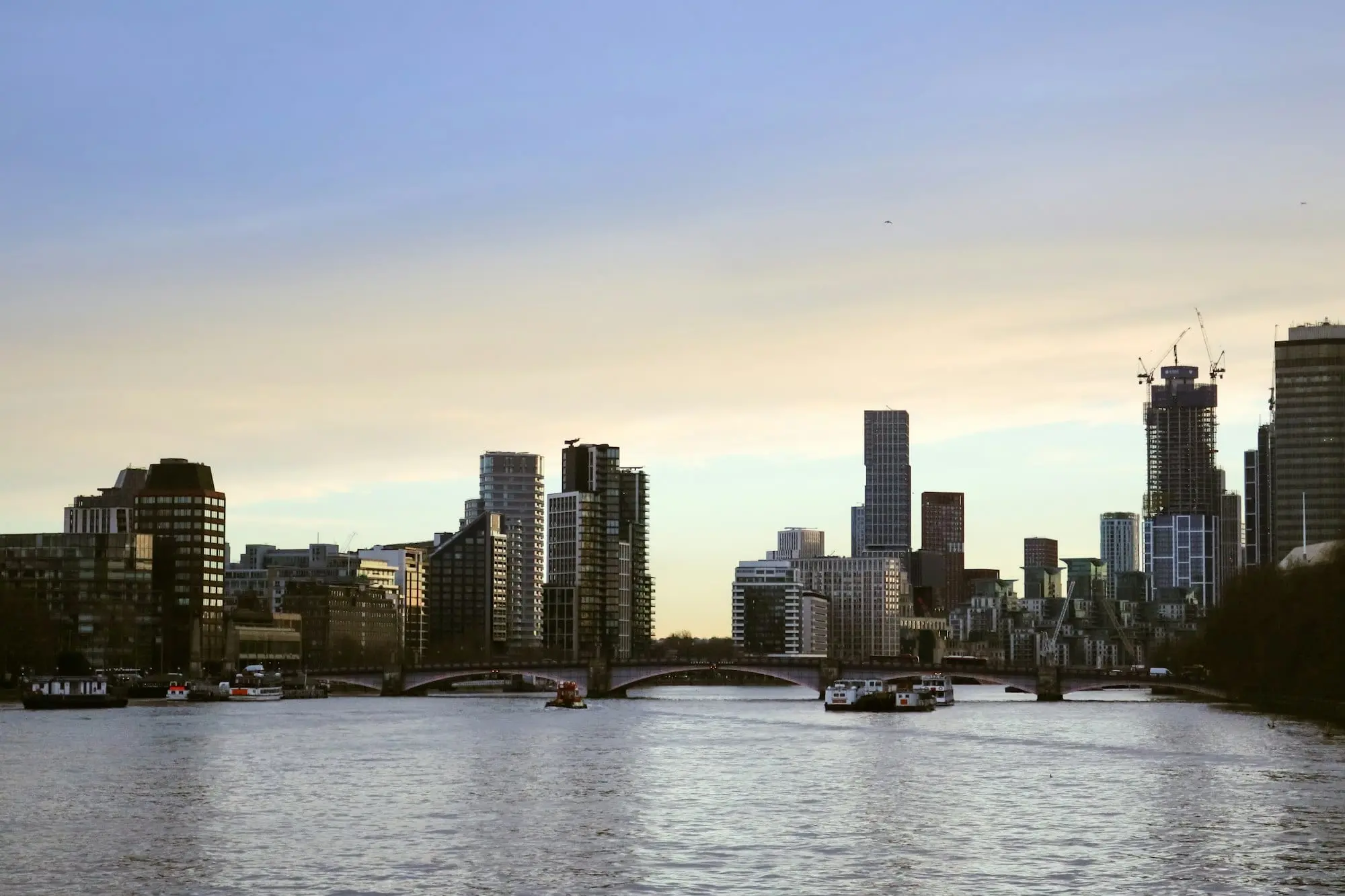 The London skyline across the River Thames at dusk